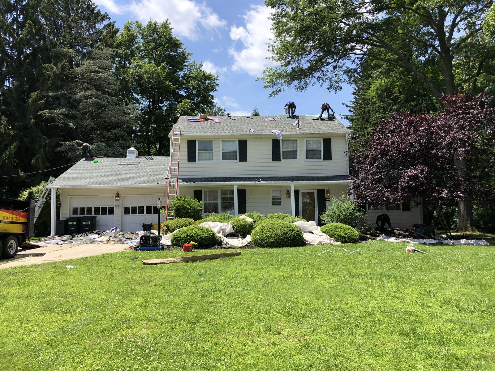 Roofers working on a house roof